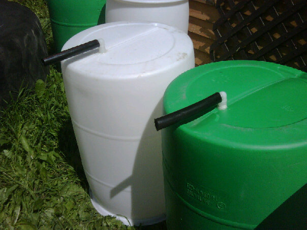 pipes-inserted-into-bottom-of-rain-barrels bottoms of the rain barrels
